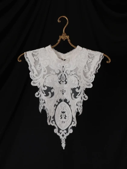 Sheer lace collar piece on a brass hanger