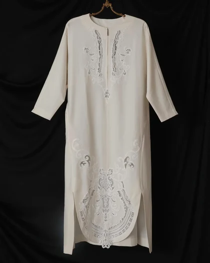 Long ivory tunic with cutwork embroidery on a brass hanger
